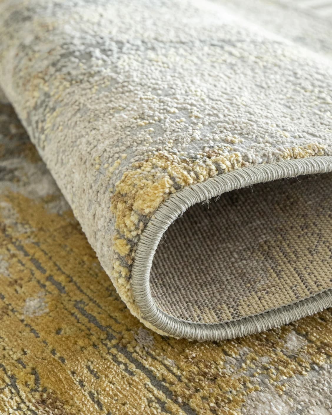 Cooper Goldberg carpet in grey and gold, shown in a product close-up as image 10