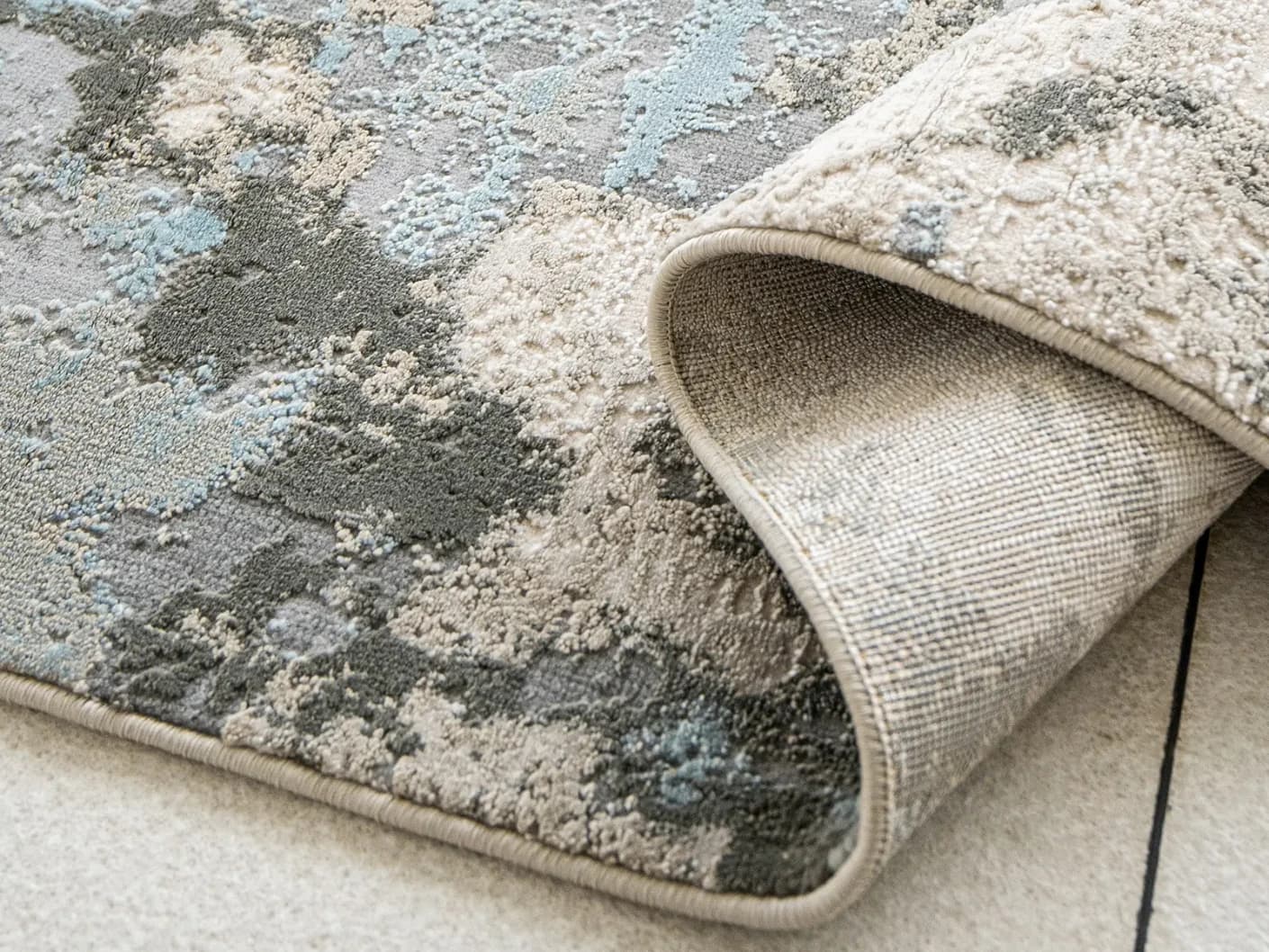 Cooper Sky carpets in sky, blue and grey, shown in a product close-up view