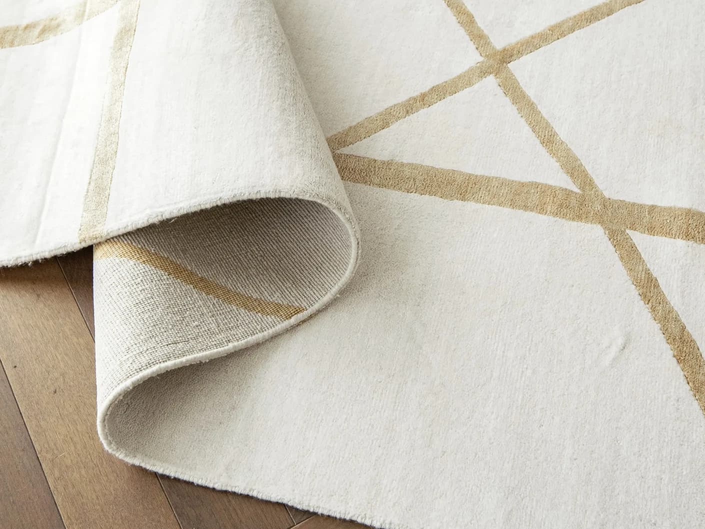Dash Goldberg carpets in gold and off white, shown in a product close-up top view