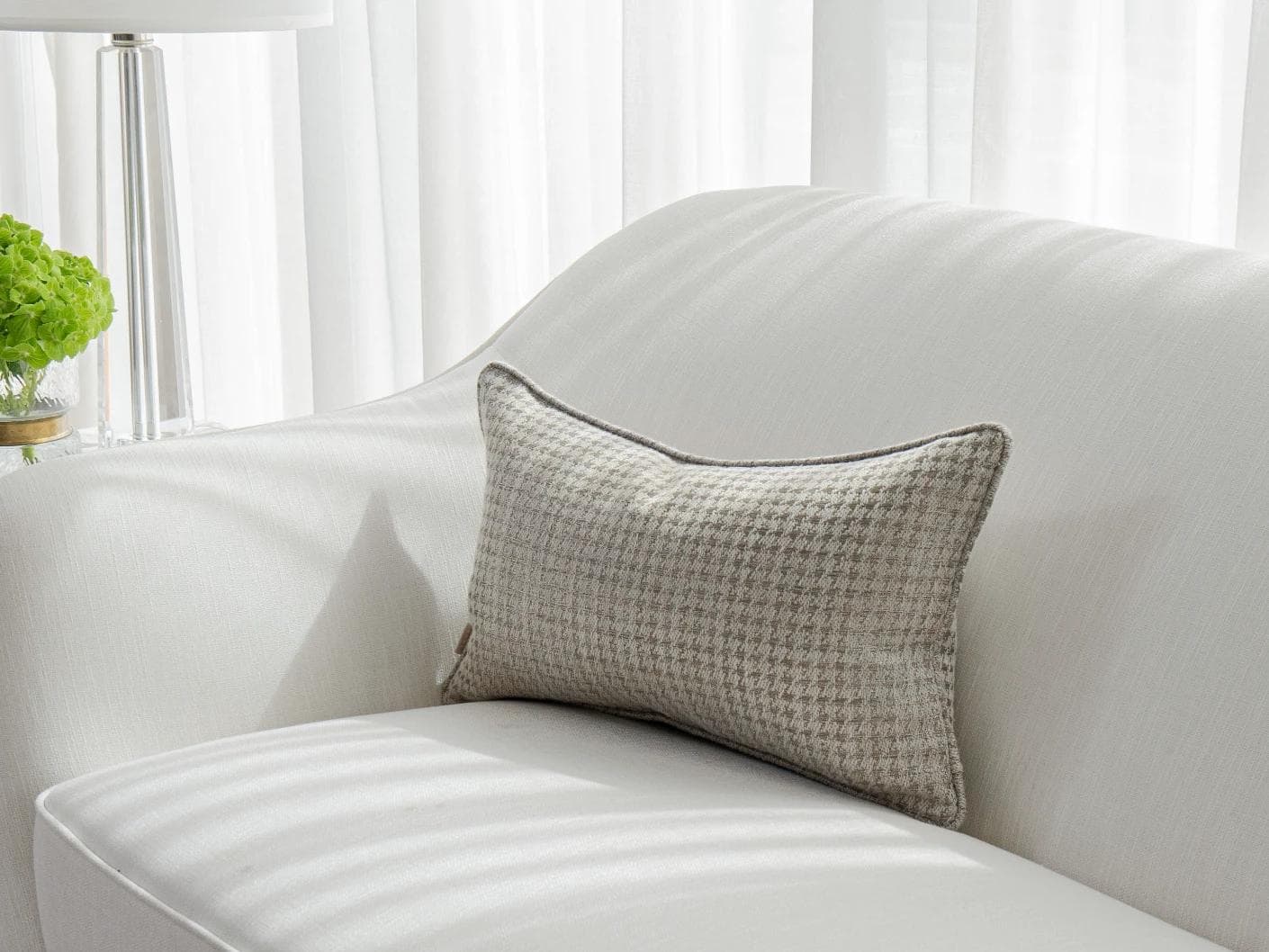 Leo Laurent II cushion in brown and silver, shown in a lifestyle front view as image 2