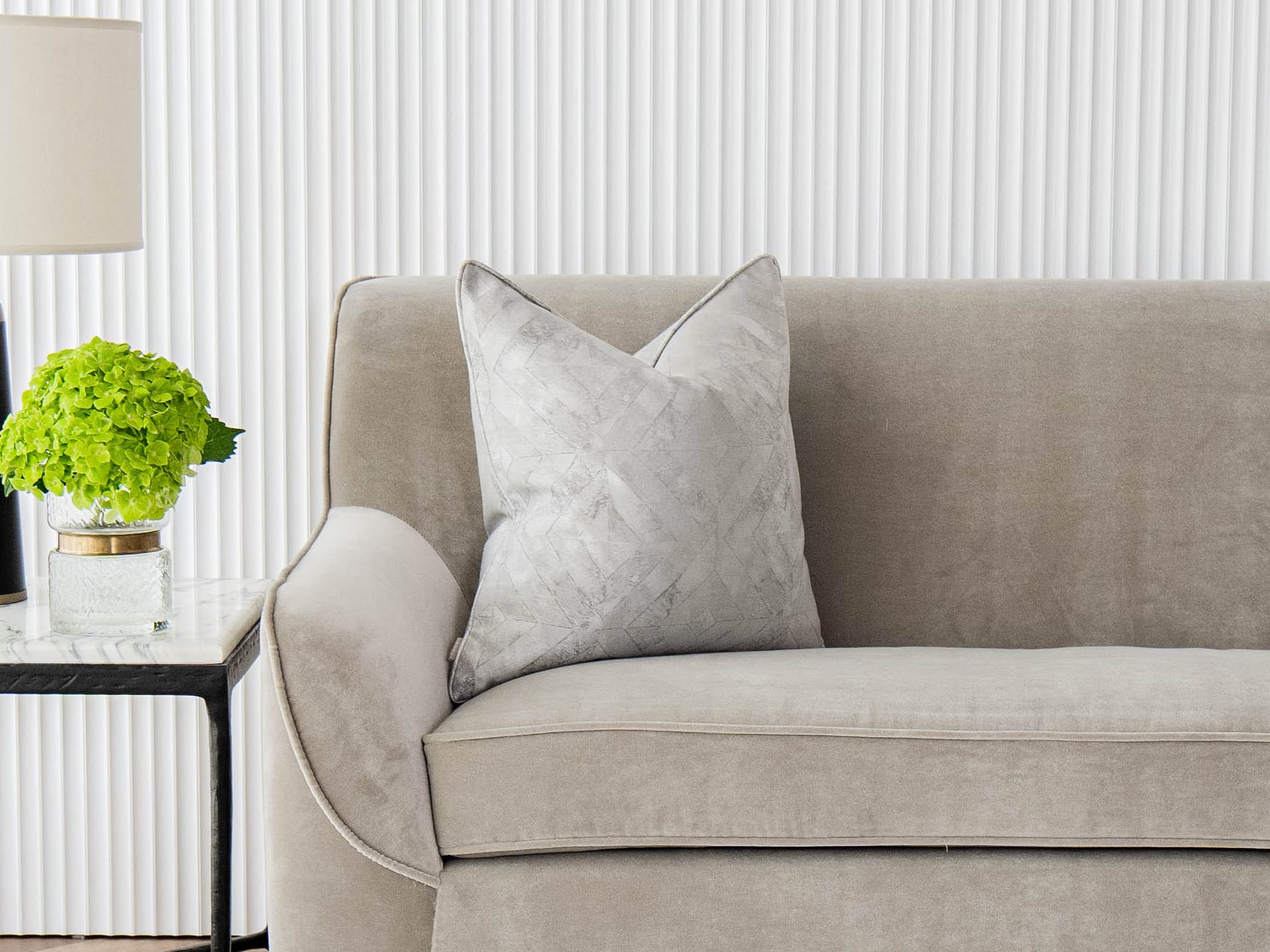 Diana Laurent single cushions in silver, shown in a lifestyle front view