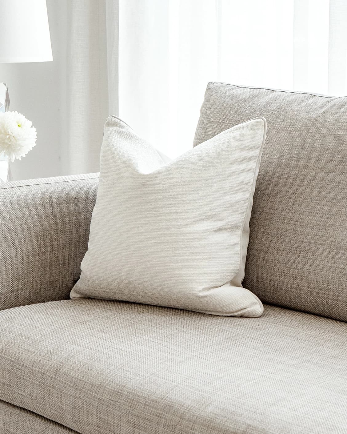 Divina Bianca cushion in white, shown in a lifestyle front view as image 2