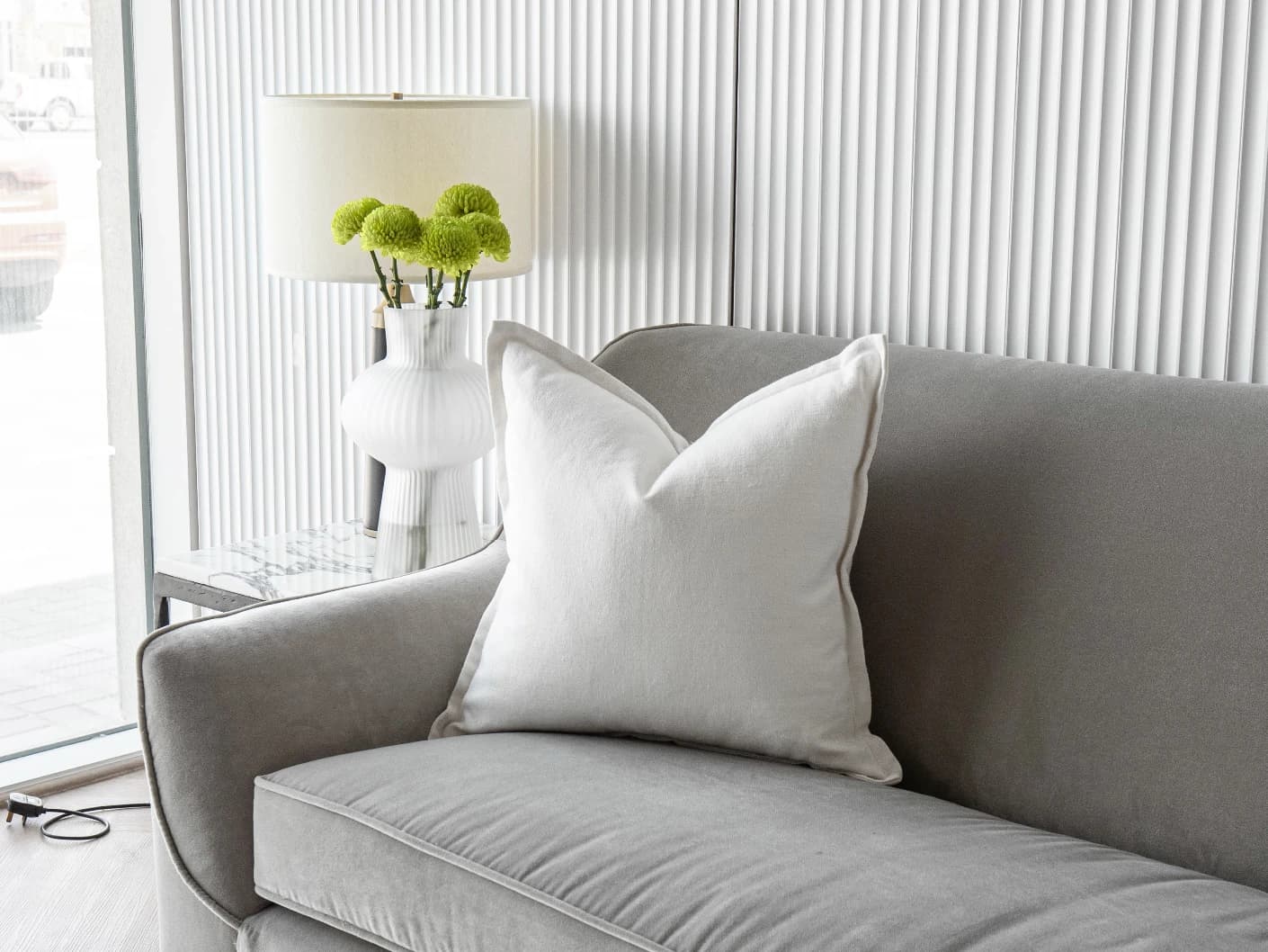 Dorothy Bianca single cushions in white, shown in a lifestyle front view