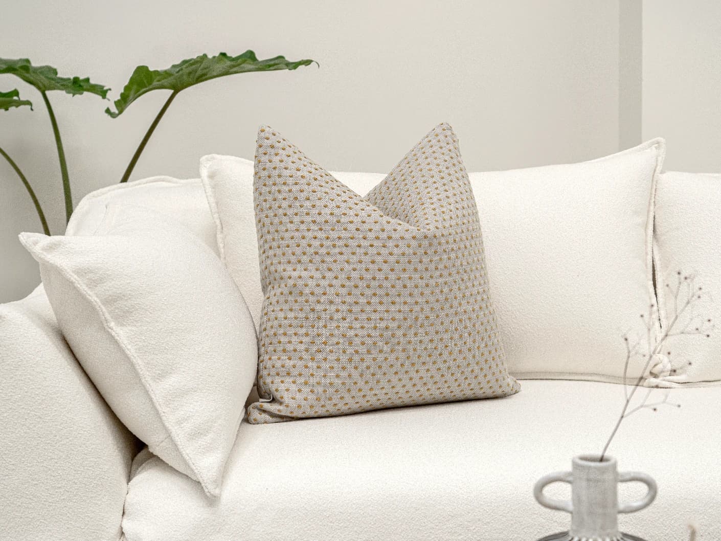Dotty Barrymore single cushions in beige, shown in a lifestyle front view