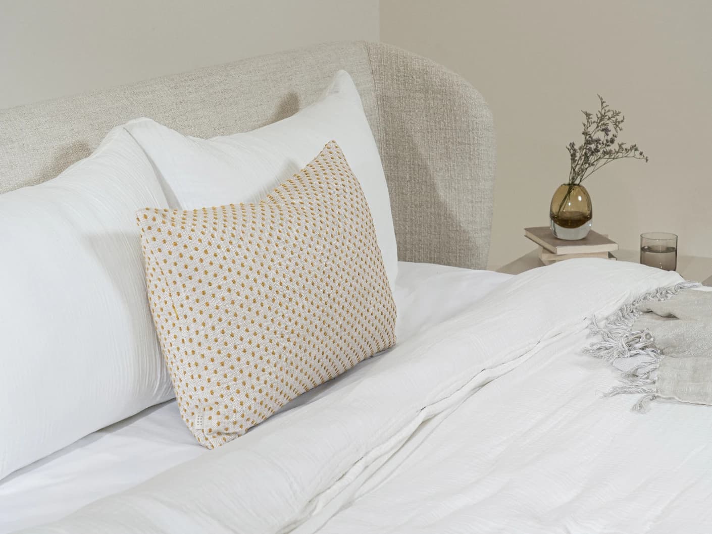 Dotty Barrymore III single cushions in beige and grey, shown in a lifestyle left view