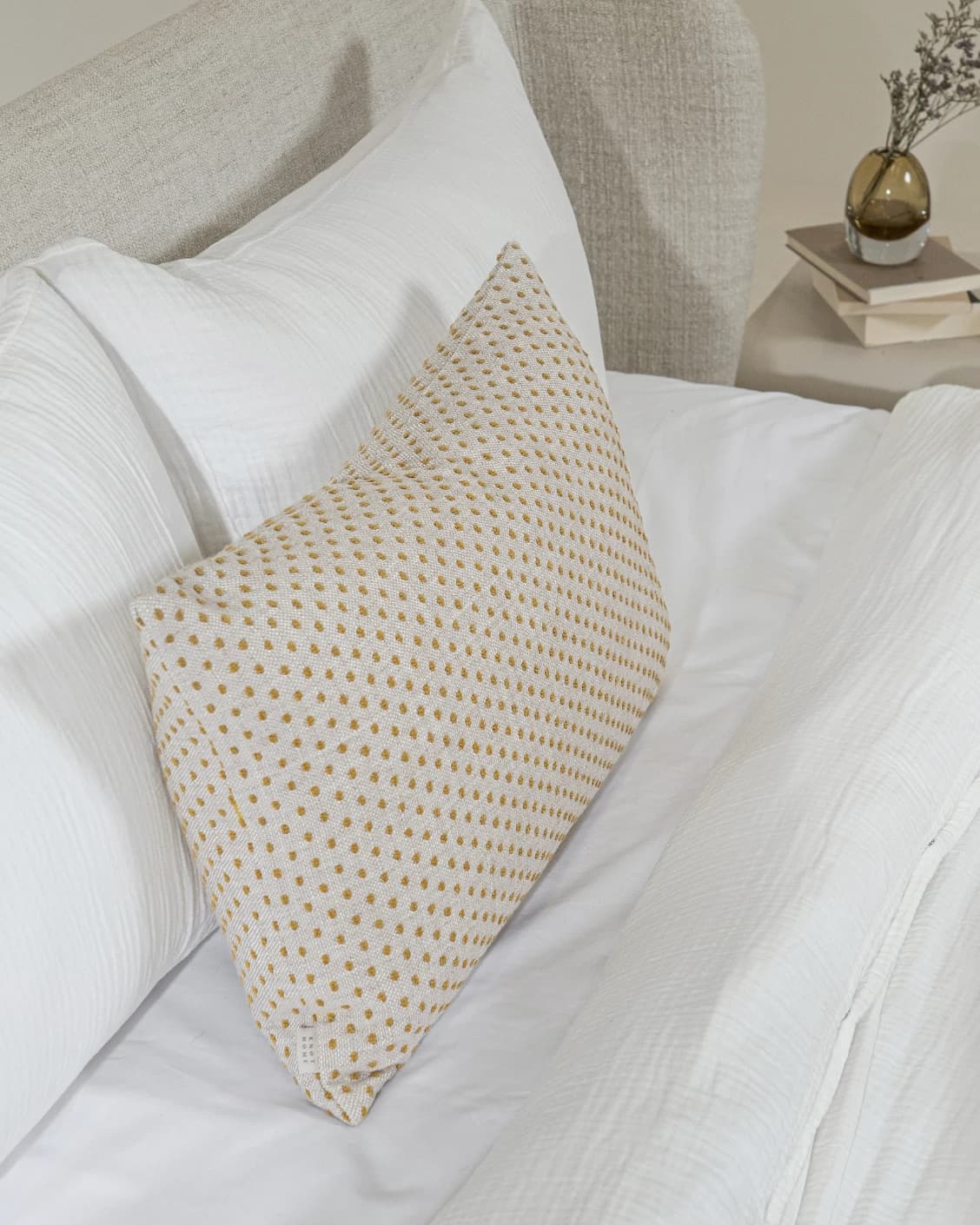 Dotty Barrymore III cushion in beige and grey, shown in a lifestyle left view as image 5