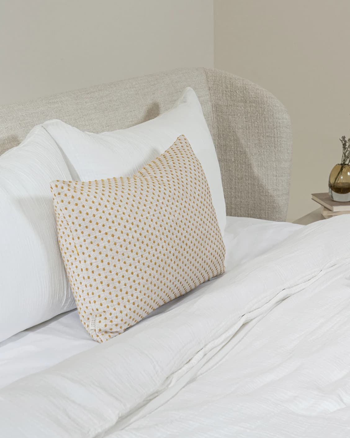 Dotty Barrymore III cushion in beige and grey, shown in a lifestyle left view as image 4