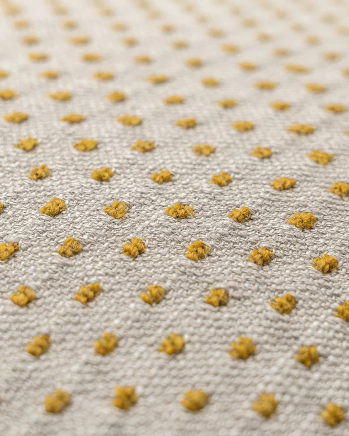 Dotty Barrymore III cushion in beige and grey, shown in a product close-up top view as image 2