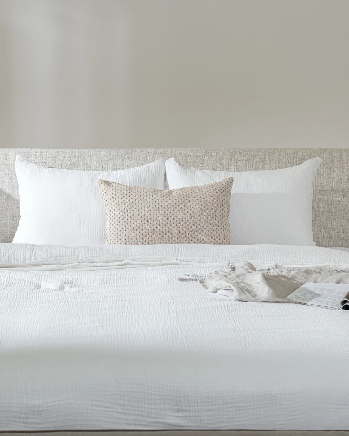 Dotty Barrymore III cushion in beige and grey, shown in a lifestyle front view as image 2
