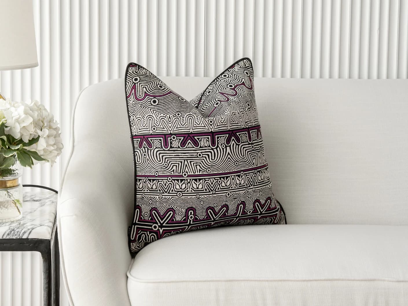 Edda Mauve single cushions in mauve, black and silver, shown in a lifestyle front view