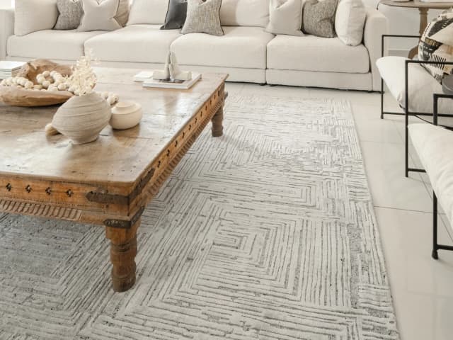 Eh Riley Stone Round carpet in beige, shown in a lifestyle left view as image 5