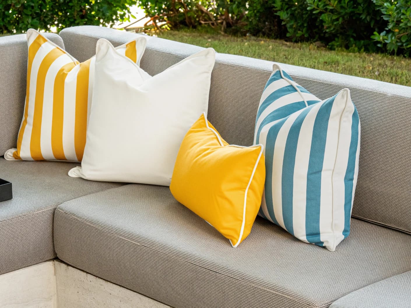 Elio Bundle bundle cushions in turquoise, yellow and ivory, shown in a lifestyle front view