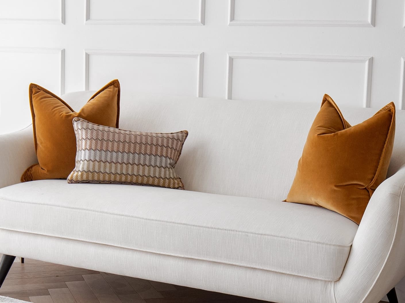Ellie Bundle bundle cushions in orange and yellow, shown in a lifestyle front view