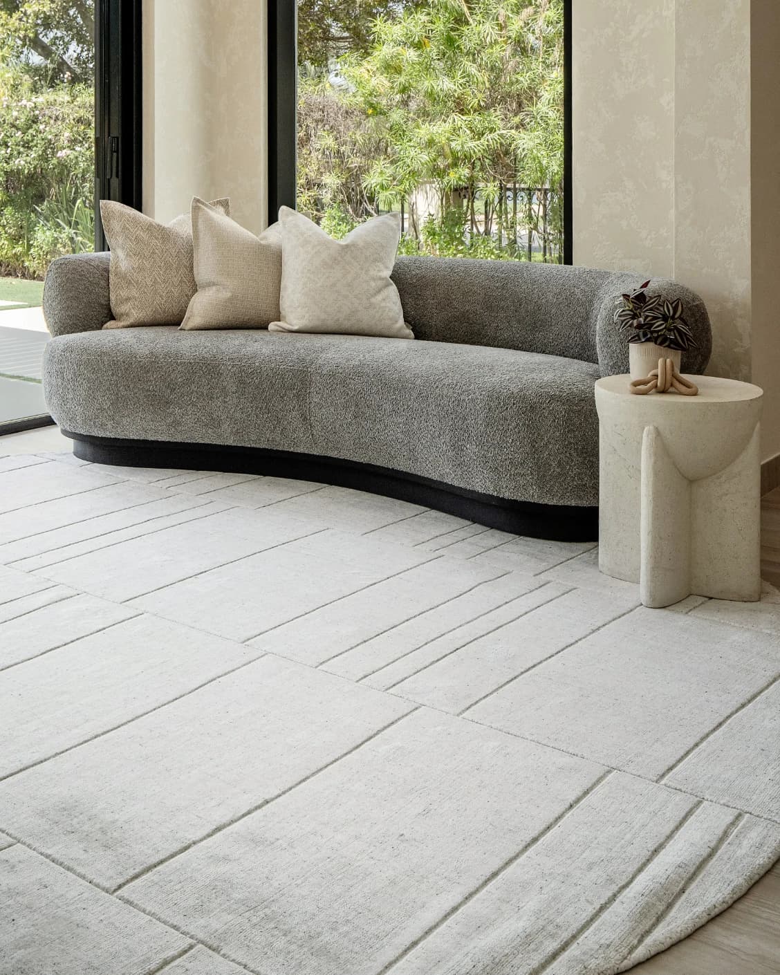 Elliot Alba Round carpet in grey and white, shown in a lifestyle front view as image 2