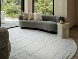 Elliot Alba Round carpet in grey and white, shown in a lifestyle front view