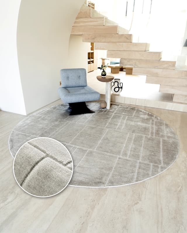 Elliot Ashton Round carpet in grey and silver, shown in a lifestyle front view as image 2