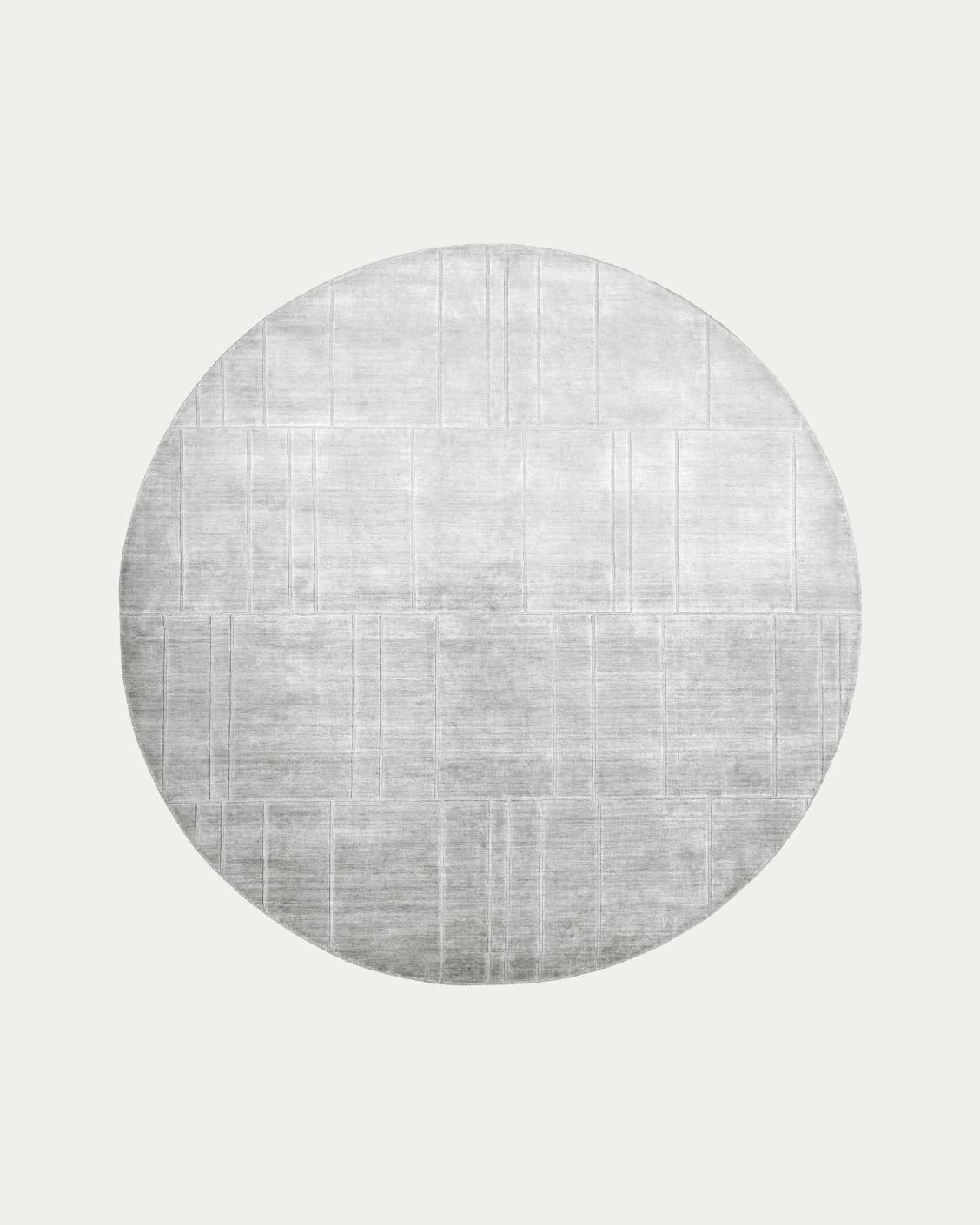 Elliot Ashton Round carpet in grey and silver, shown in a lifestyle front view as image 1