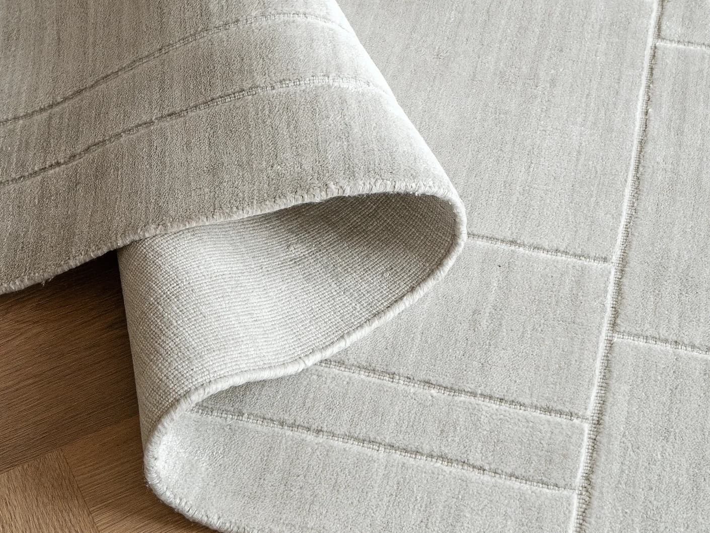 Elliot Ashton carpets in grey and silver, shown in a product close-up top view