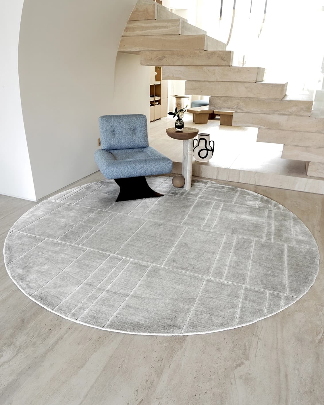 Elliot Ashton Round carpet in grey and silver, shown in a lifestyle front view as image 2