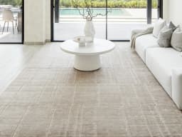 Elliot Sandy carpet in sandy, beige and taupe, shown in a lifestyle front view