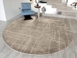 Elliot Sandy Round carpet in sandy, beige and taupe, shown in a lifestyle front view