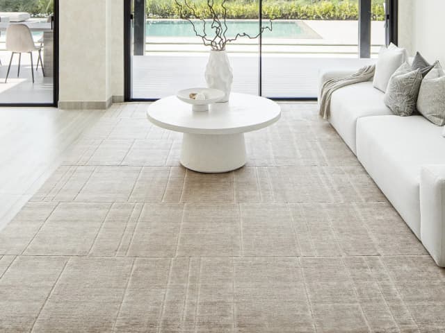 Elliot Sandy carpets in beige and taupe, shown in a lifestyle close-up top view as image 1