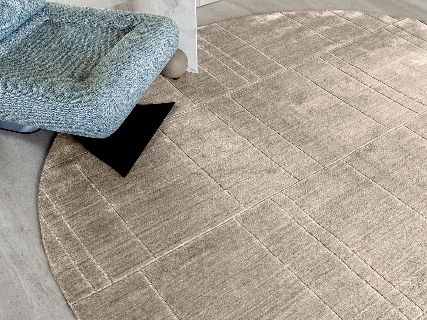 Elliot Sandy carpets in beige and taupe, shown in a lifestyle close-up top view as image 1