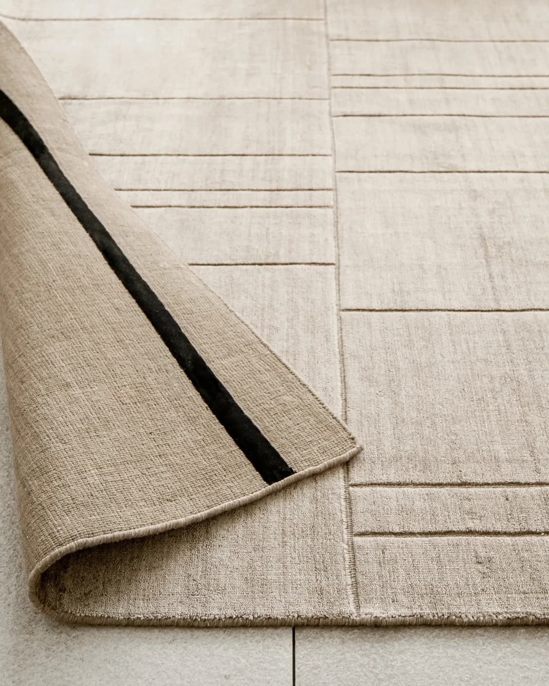 Elliot Sandy carpet in beige and taupe, shown in a lifestyle close-up as image 4