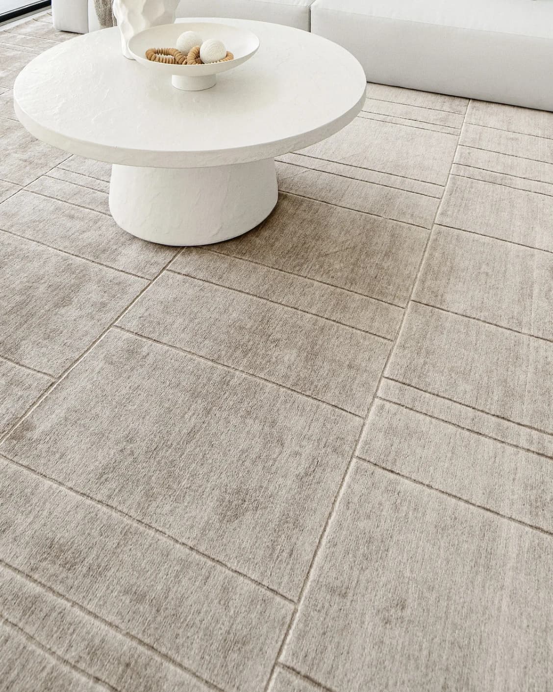 Elliot Sandy carpet in beige and taupe, shown in a lifestyle close-up as image 5