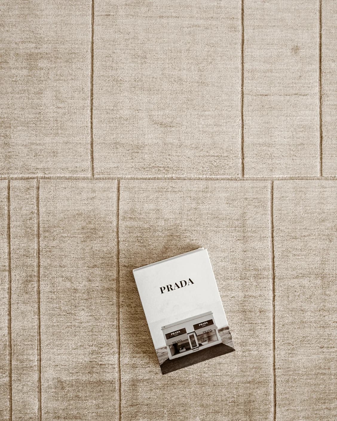 Elliot Sandy carpet in beige and taupe, shown in a lifestyle top view as image 10