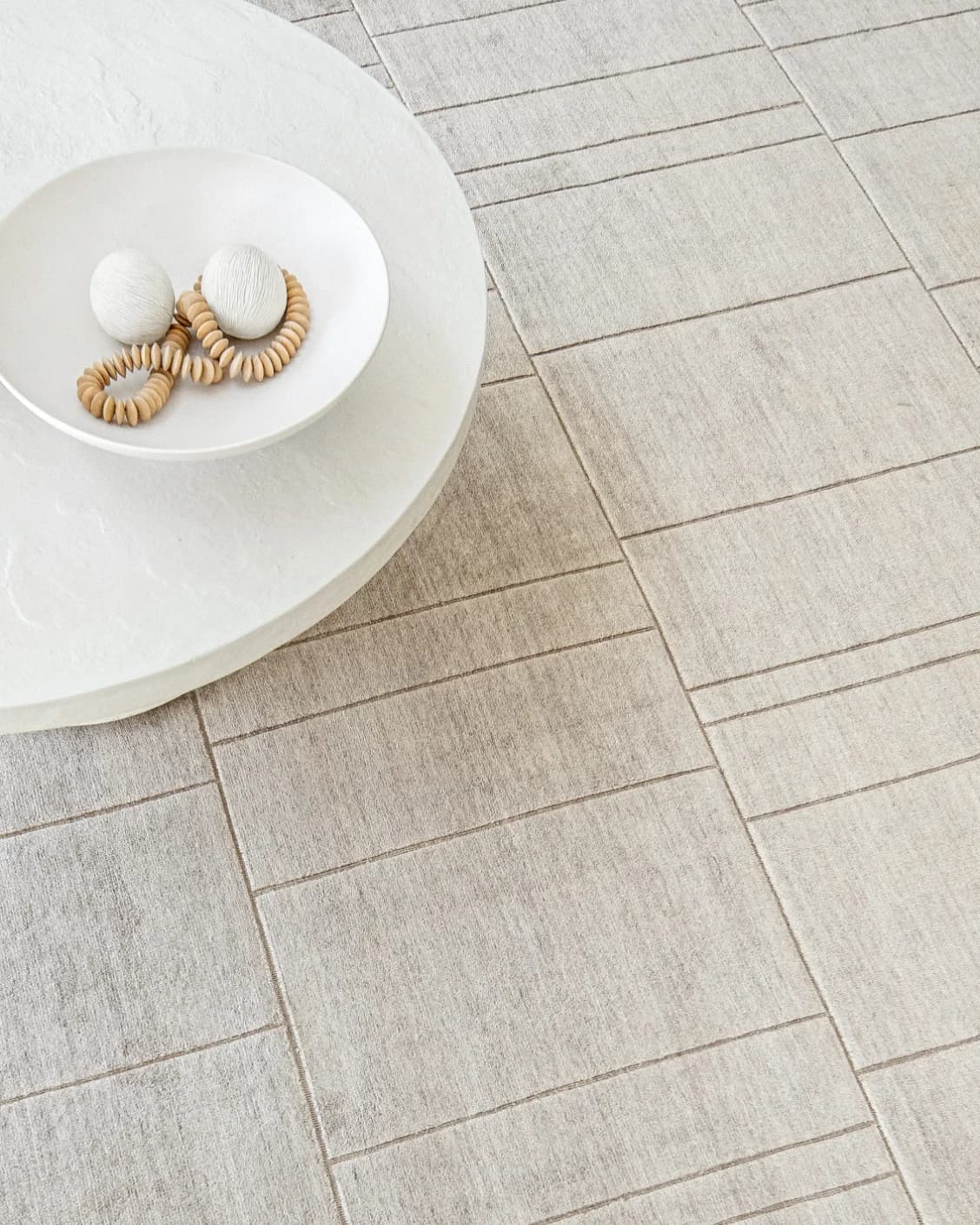 Elliot Sandy carpet in beige and taupe, shown in a lifestyle top view as image 11