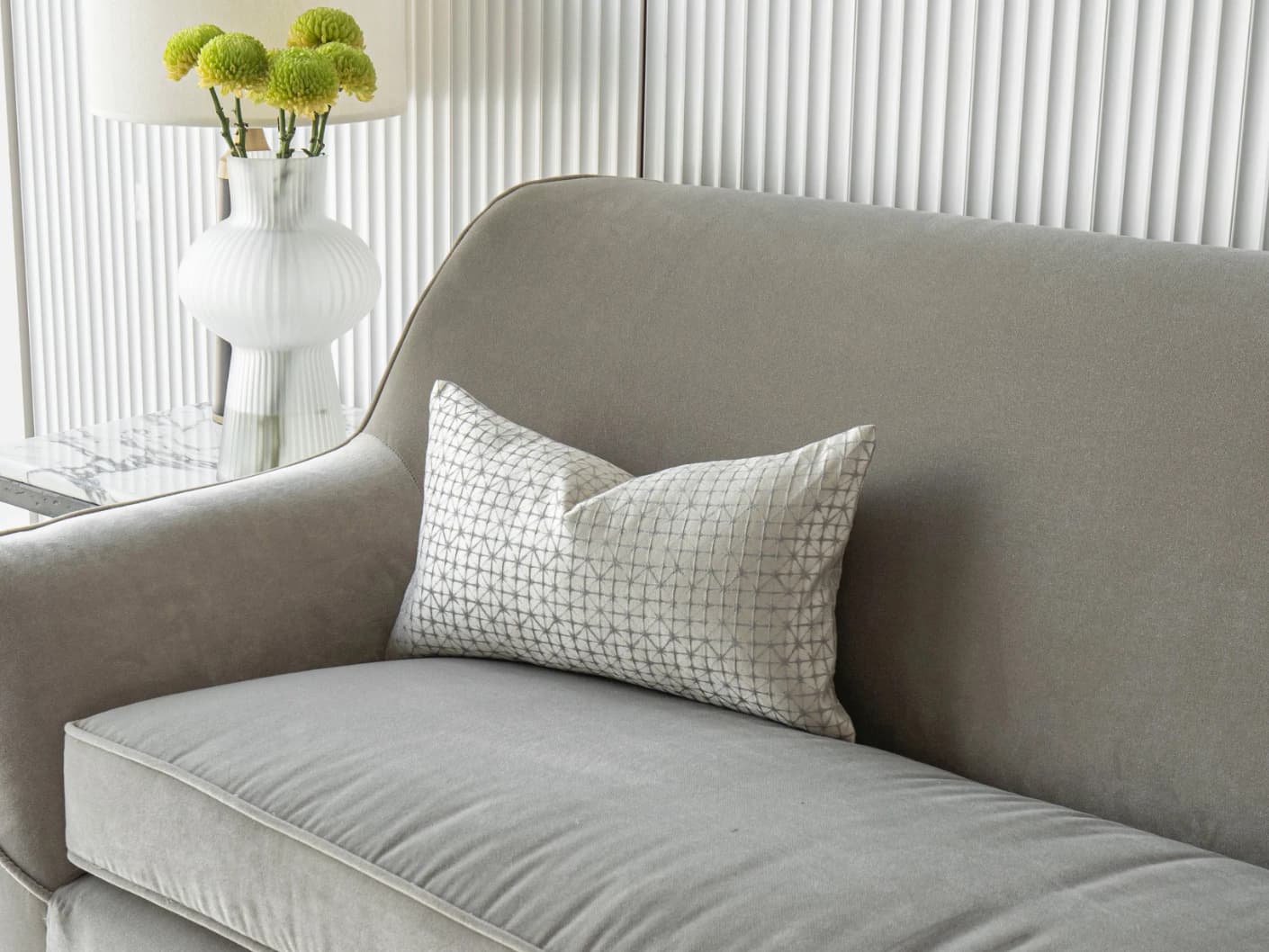 Elmas Klimt II single cushions in silver and white, shown in a lifestyle front view
