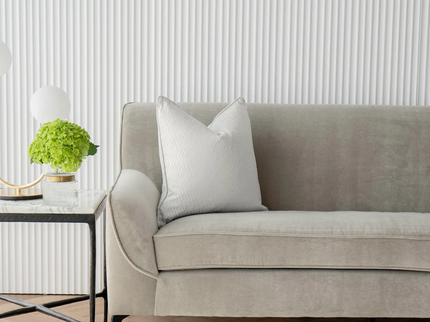 Elodie Bianca single cushions in silver, shown in a lifestyle front view