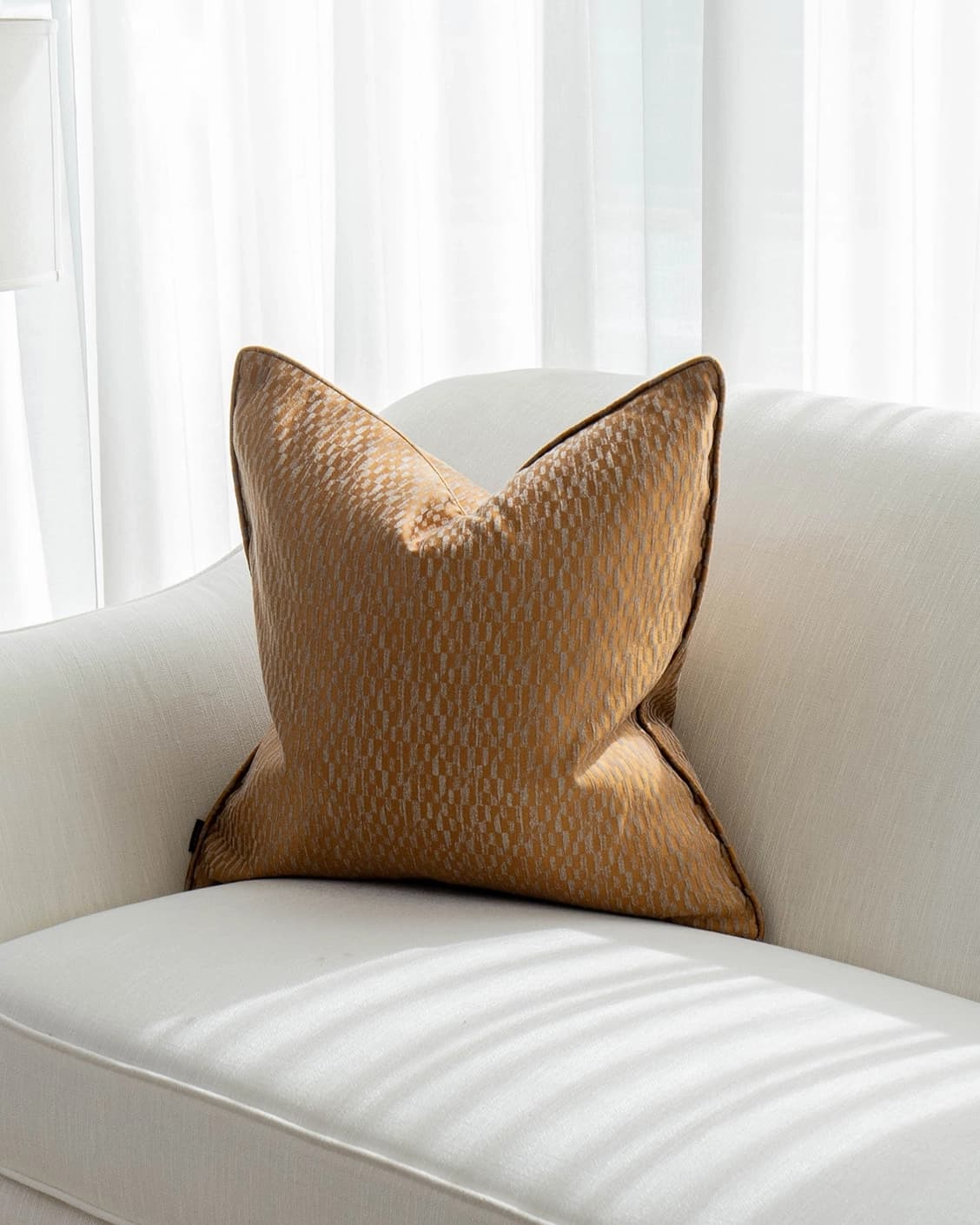 Elodie Hodler cushion in silver and orange, shown in a lifestyle front view as image 2