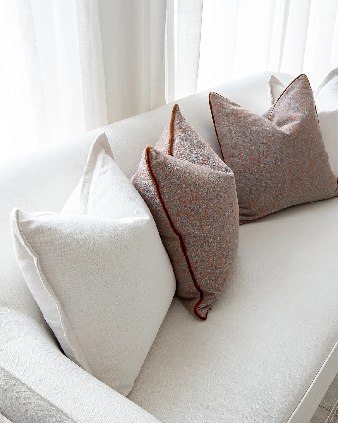 Eloise Bundle cushion in white and orange, shown in a product left view as image 6