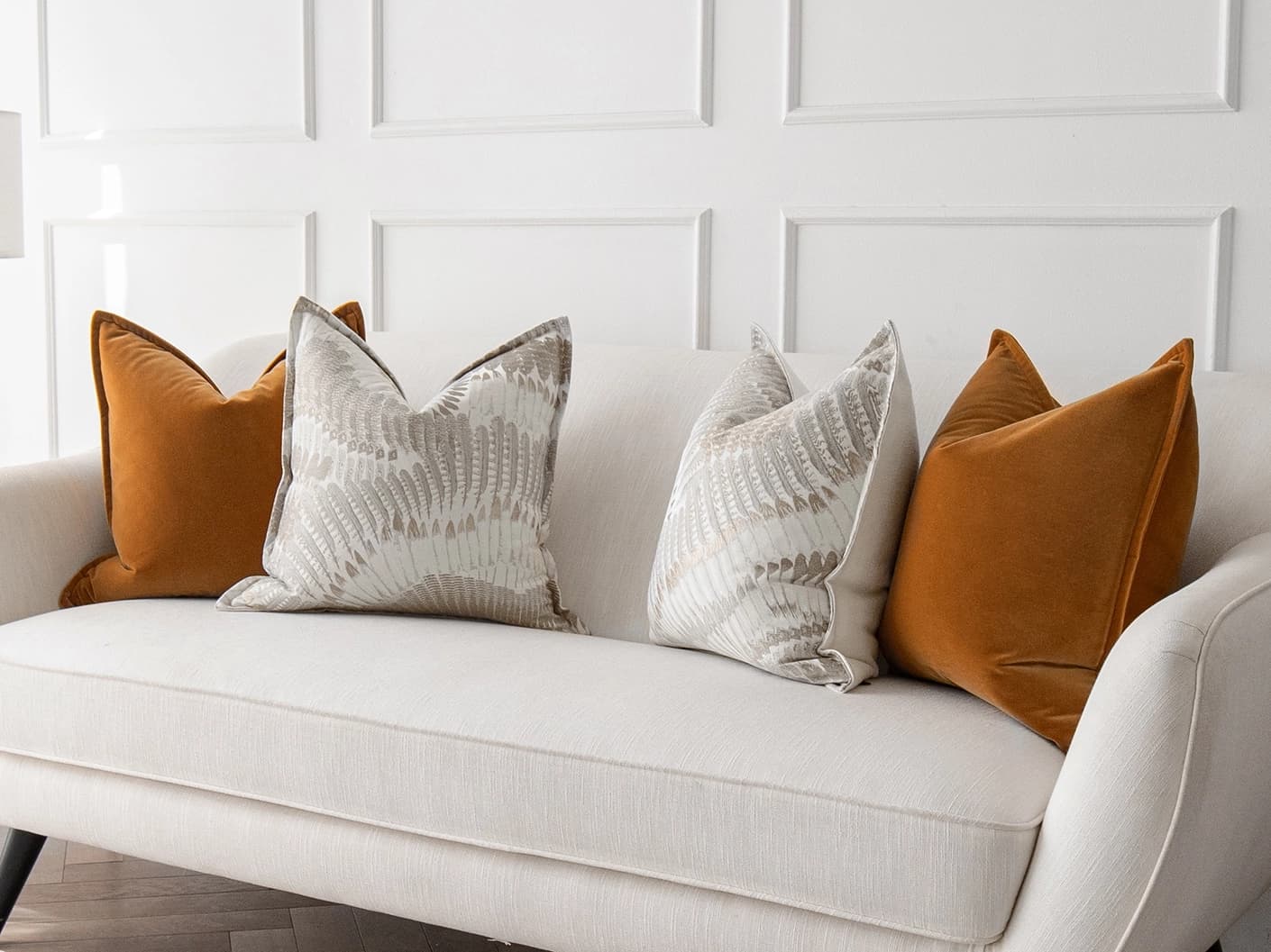 Emilia Bundle bundle cushions in orange, brown and grey, shown in a lifestyle front view