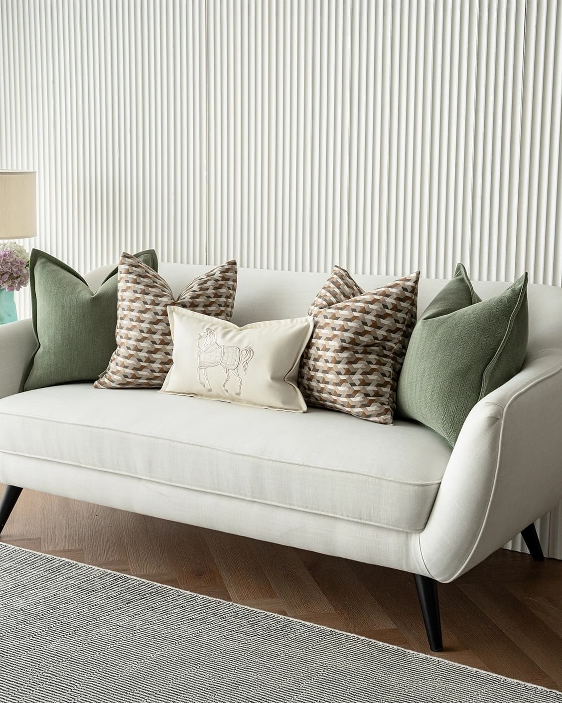 Emmanuela Bundle cushion in orange, beige, white and green, shown in a lifestyle right view as image 2