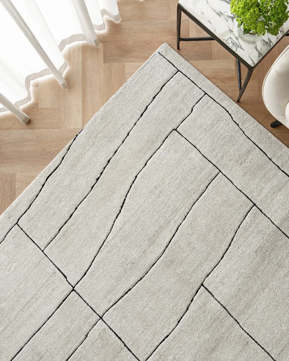 Emme Bianca carpet in off white, shown in a lifestyle top view as image 2
