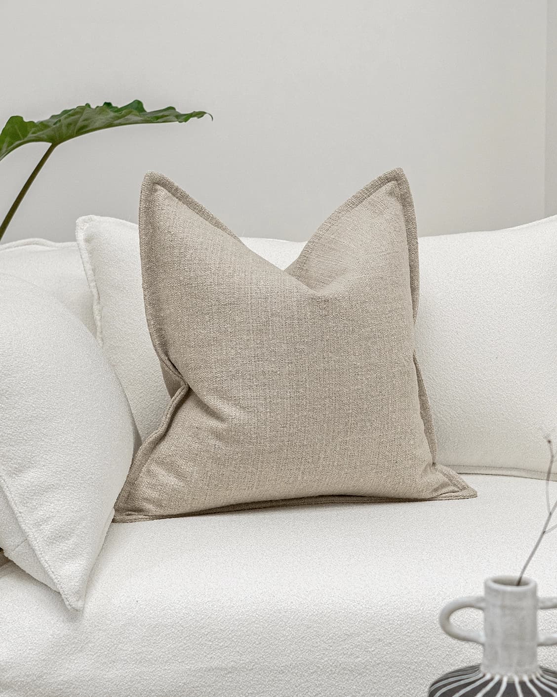 Emmett Alba cushion in beige, shown in a lifestyle front view as image 2