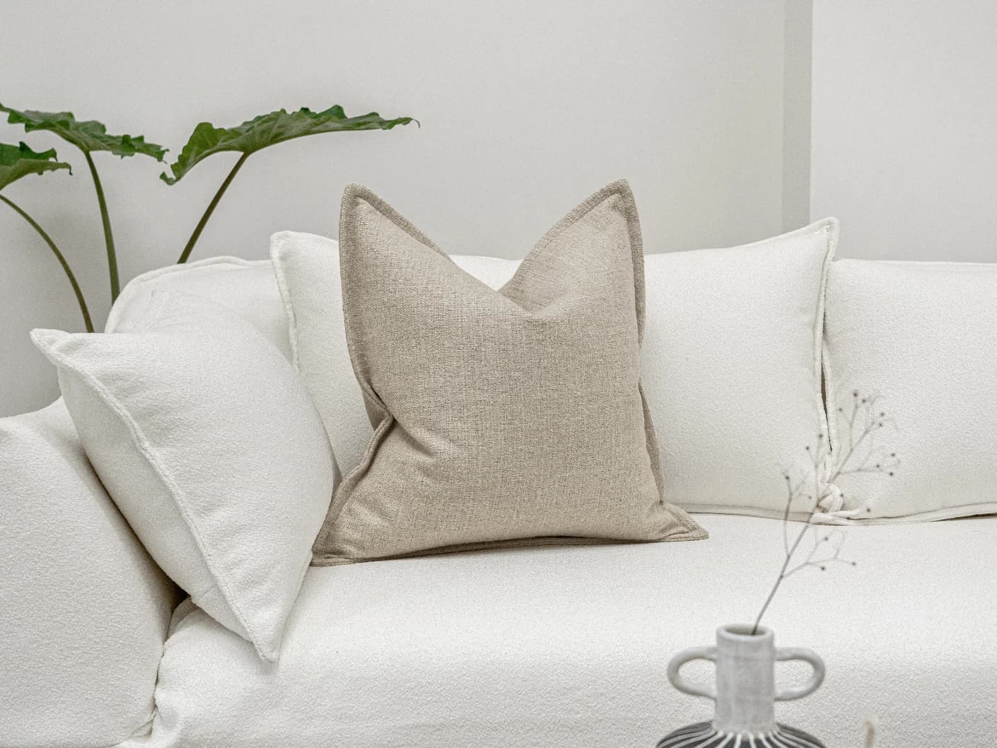 Emmett Alba single cushions in beige, shown in a lifestyle front view