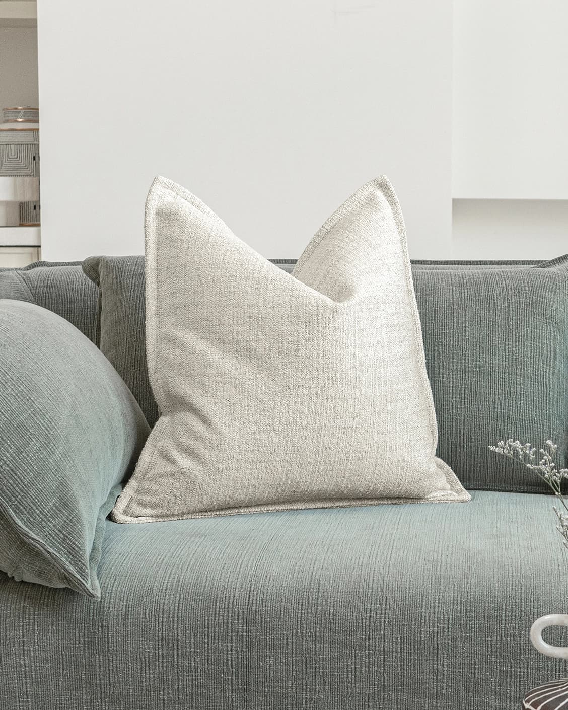 Emmett Bianca cushion in off white, shown in a lifestyle front view as image 2