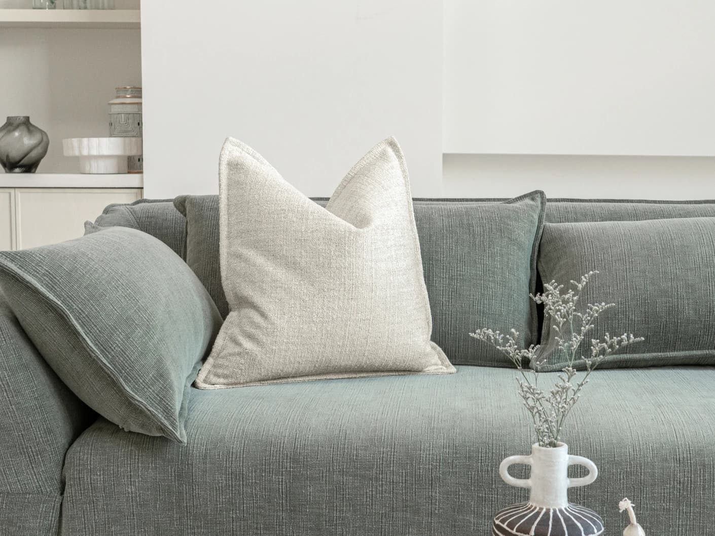 Emmett Bianca single cushions in off white, shown in a lifestyle front view