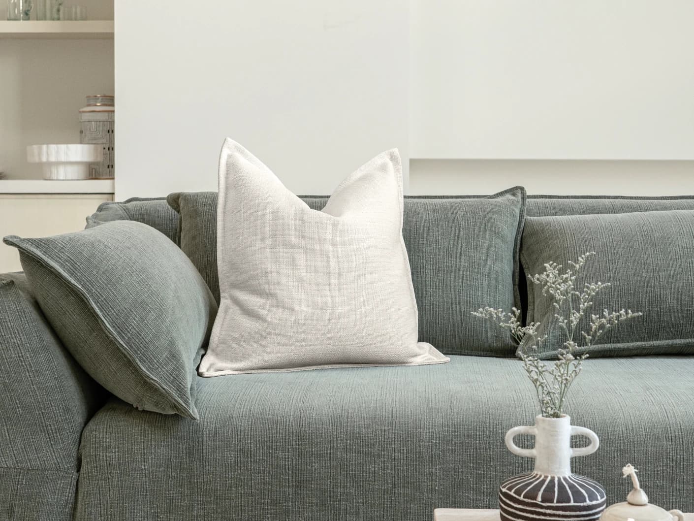 Emmett Jasmine single cushions in white, shown in a lifestyle front view