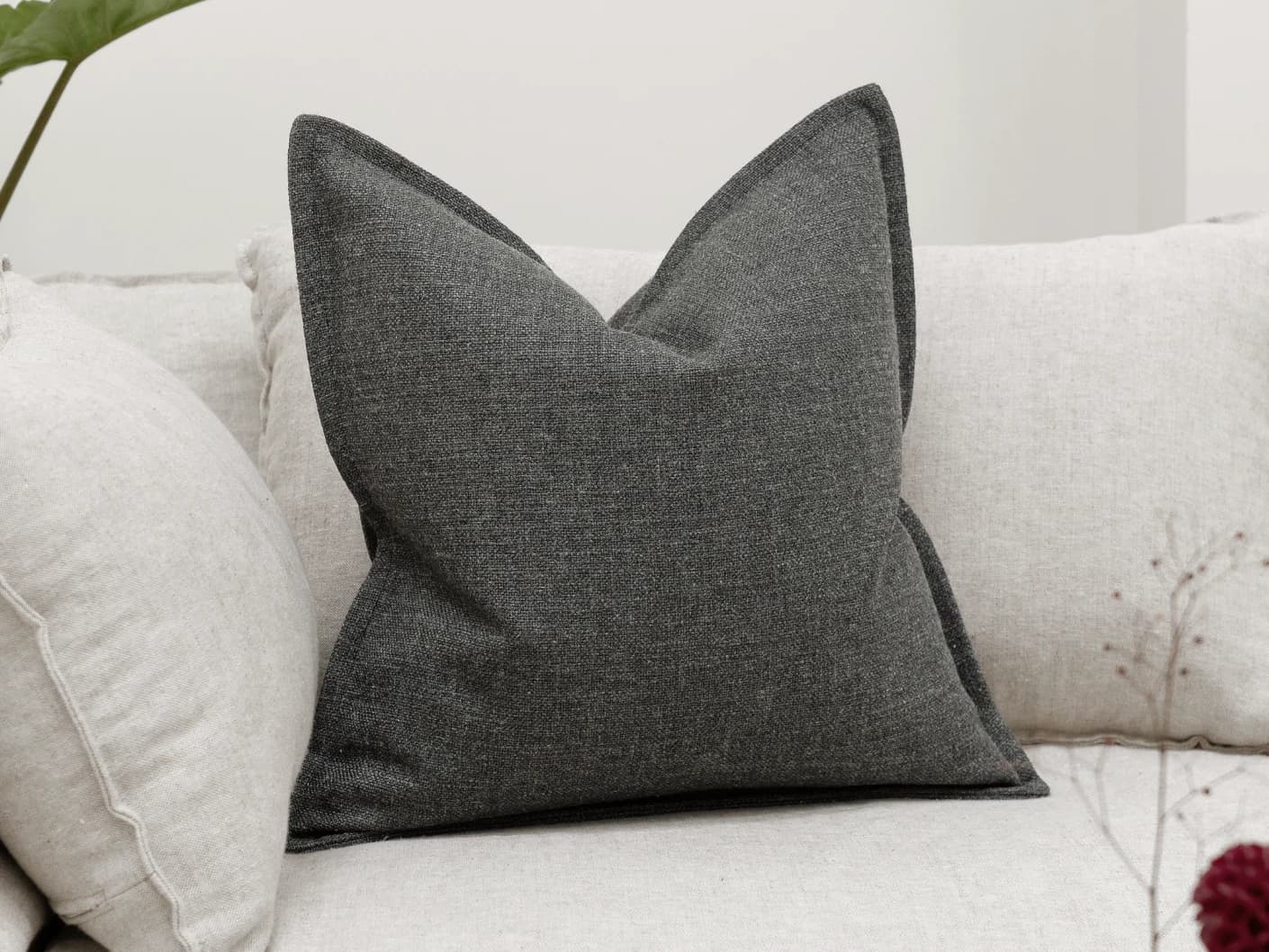 Emmett Nyx single cushions in grey, shown in a lifestyle front view