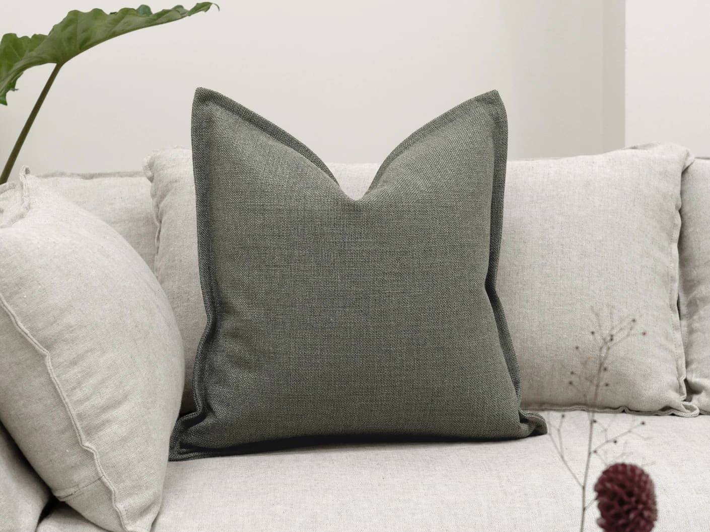 Emmett Olive single cushions in olive and green, shown in a lifestyle front view