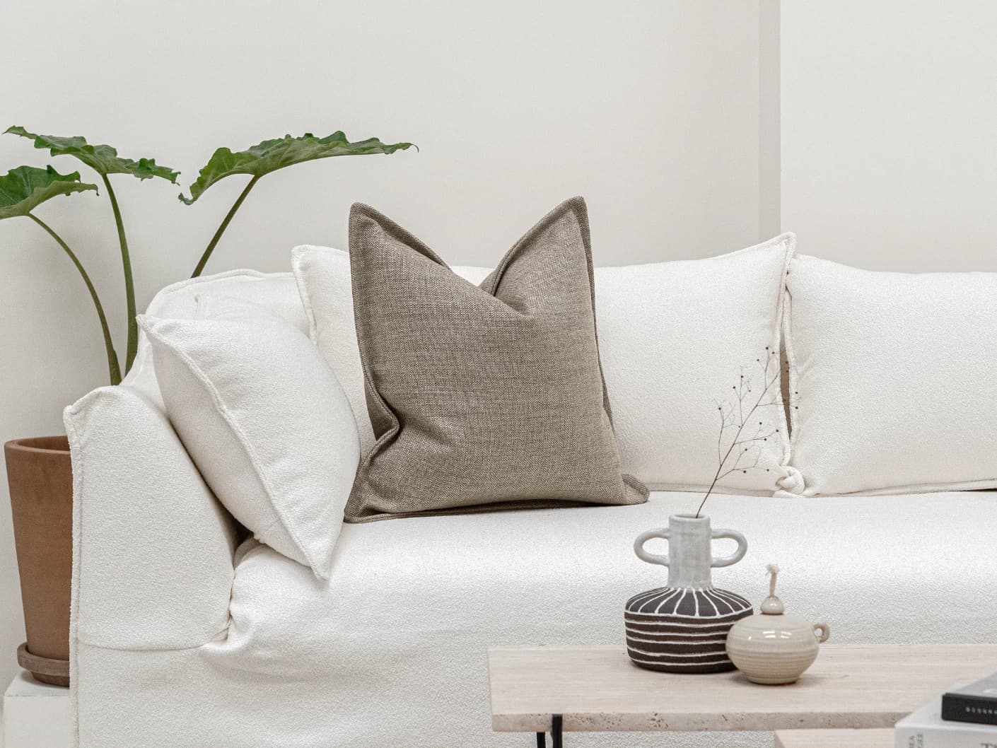 Emmett Quell single cushions in taupe and grey, shown in a lifestyle front view