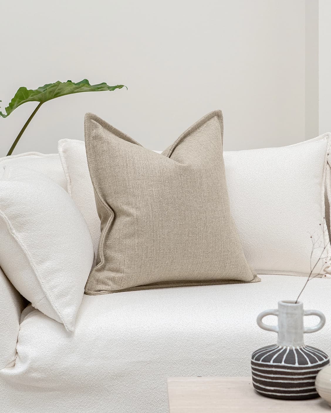 Emmett Shale cushion in beige, shown in a lifestyle front view as image 2