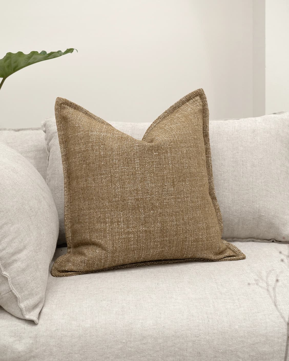 Emmett Tawna cushion in brown, shown in a lifestyle front view as image 2