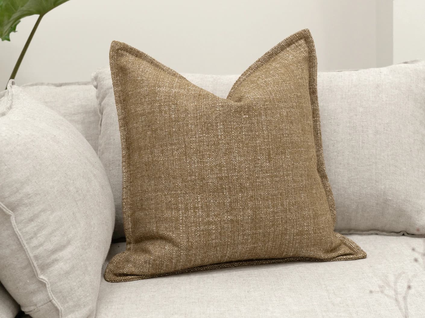 Emmett Tawna single cushions in brown, shown in a lifestyle front view