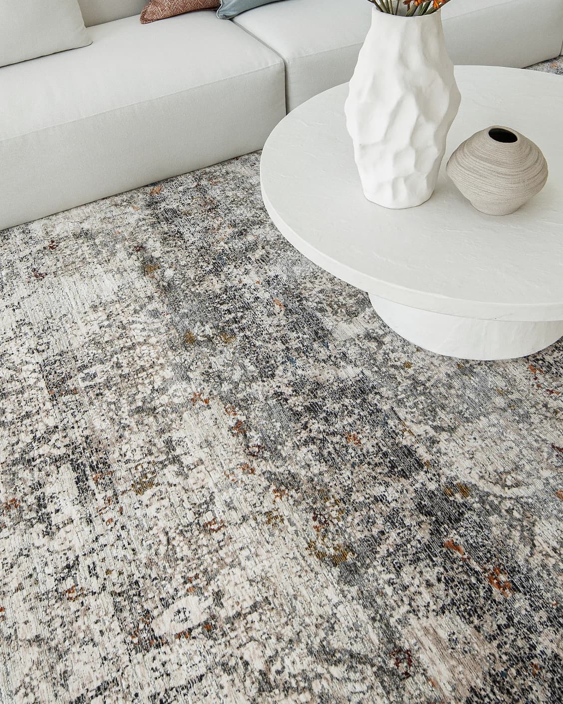 Ethan Ashton carpet in grey and beige, shown in a lifestyle top view as image 9